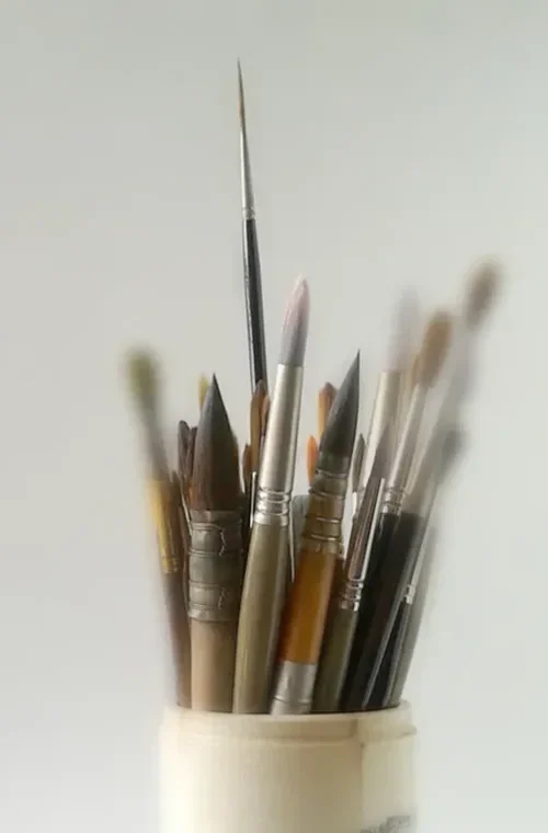 Pincéis de aguarela num frasco. Imagem de apresentação do estúdio do artista A Dantas, especializada em aguarelas originais e retratos por encomenda.